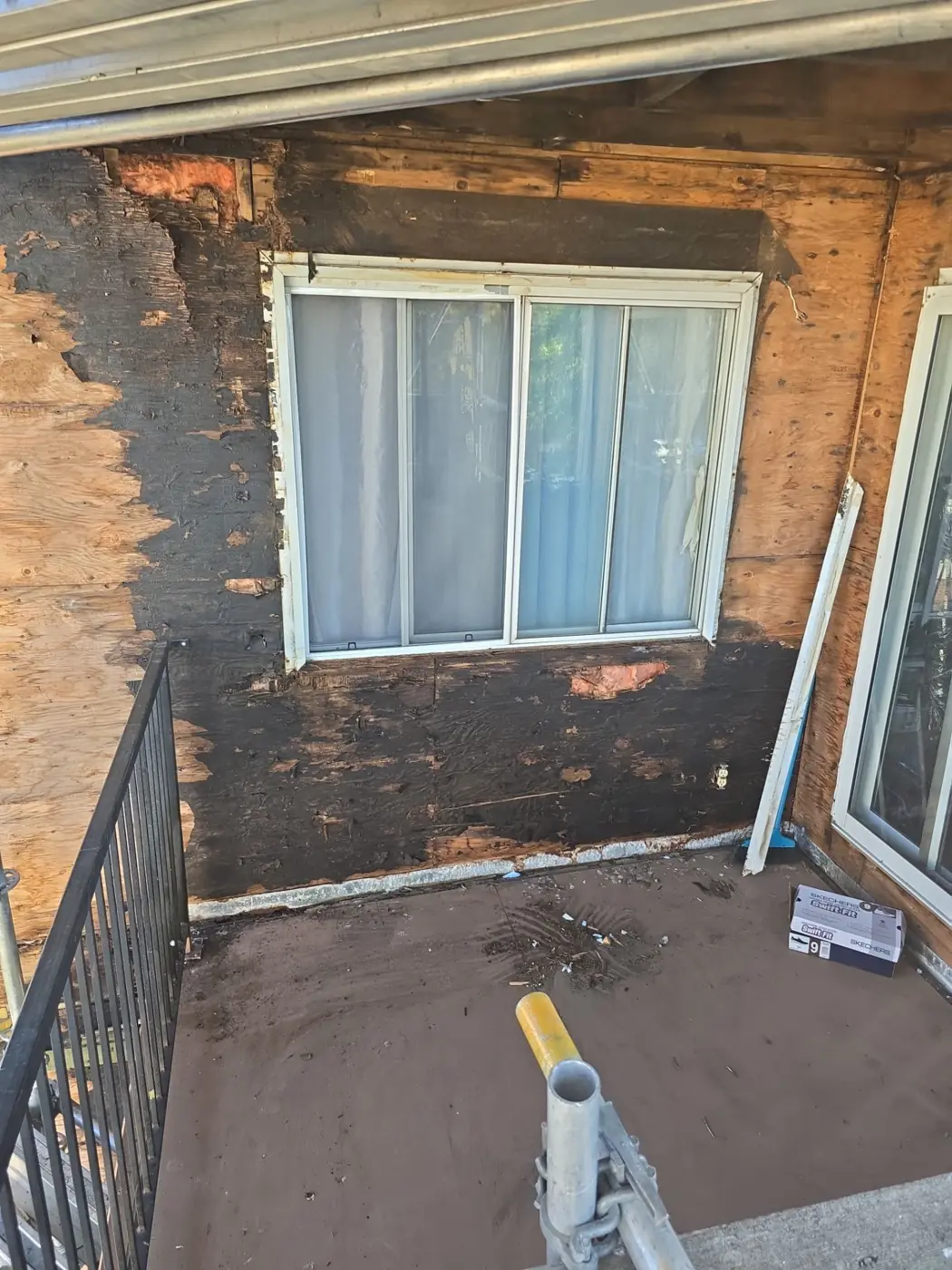 Balcony wall stripped back to sheathing