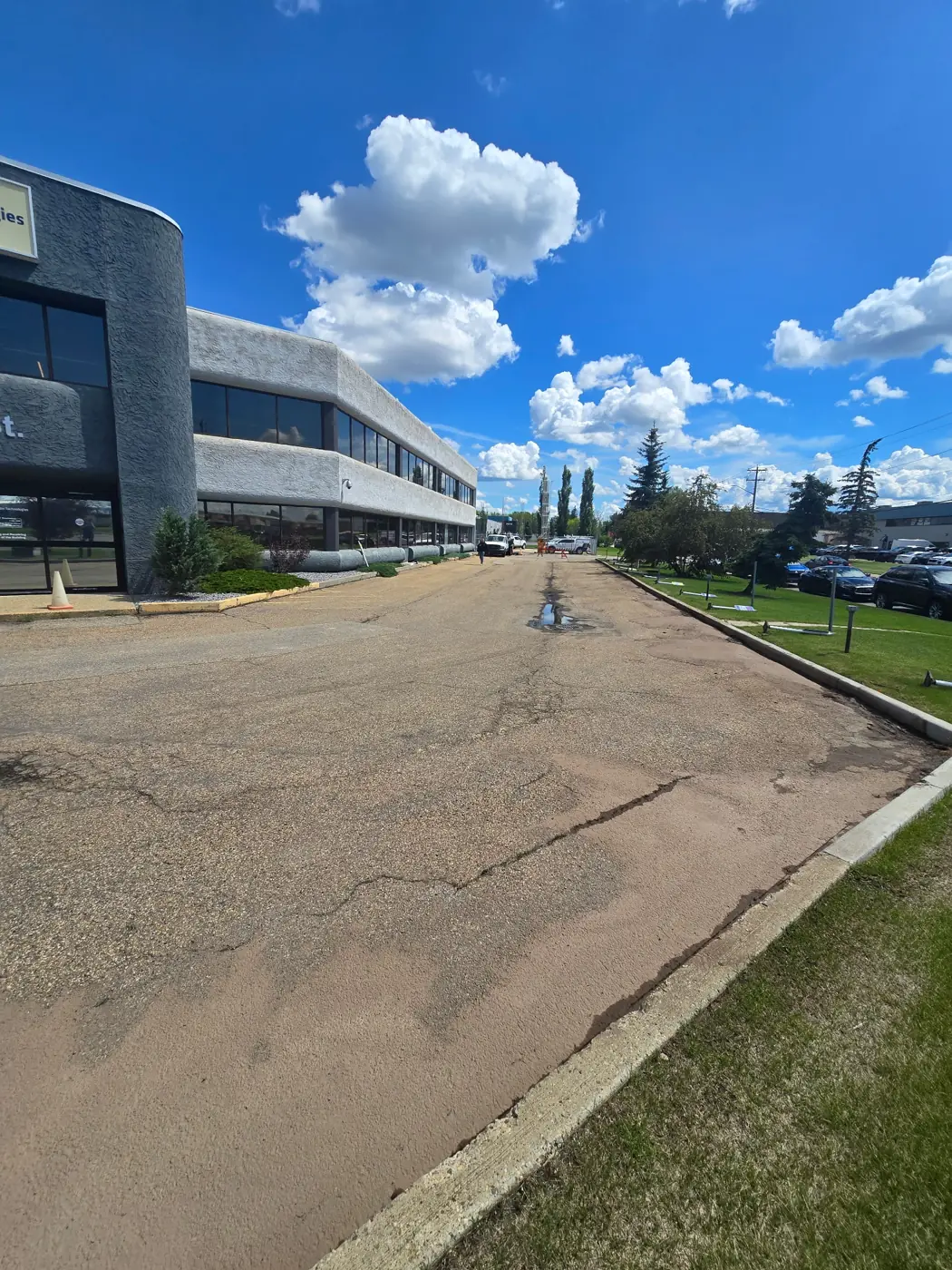 Commercial parking lot before repaving — worn, cracked asphalt