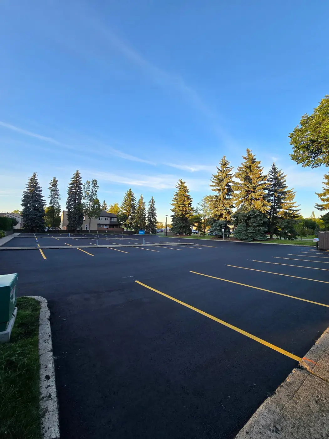 Newly paved parking lot with fresh yellow stall lines
